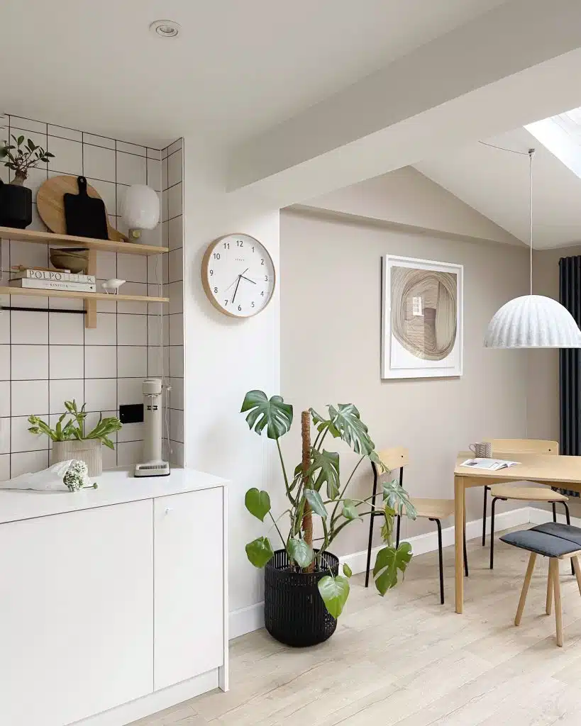 a living room filled with furniture and a clock