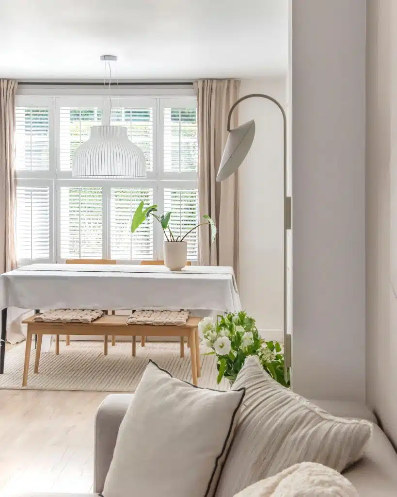 a living room filled with furniture and a large window