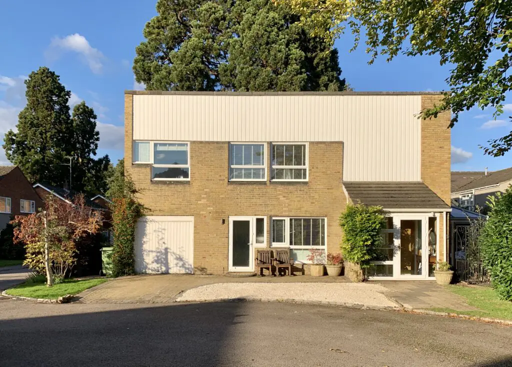 a tree in front of a brick building