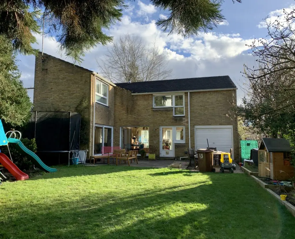 a house with a lawn in front of a building